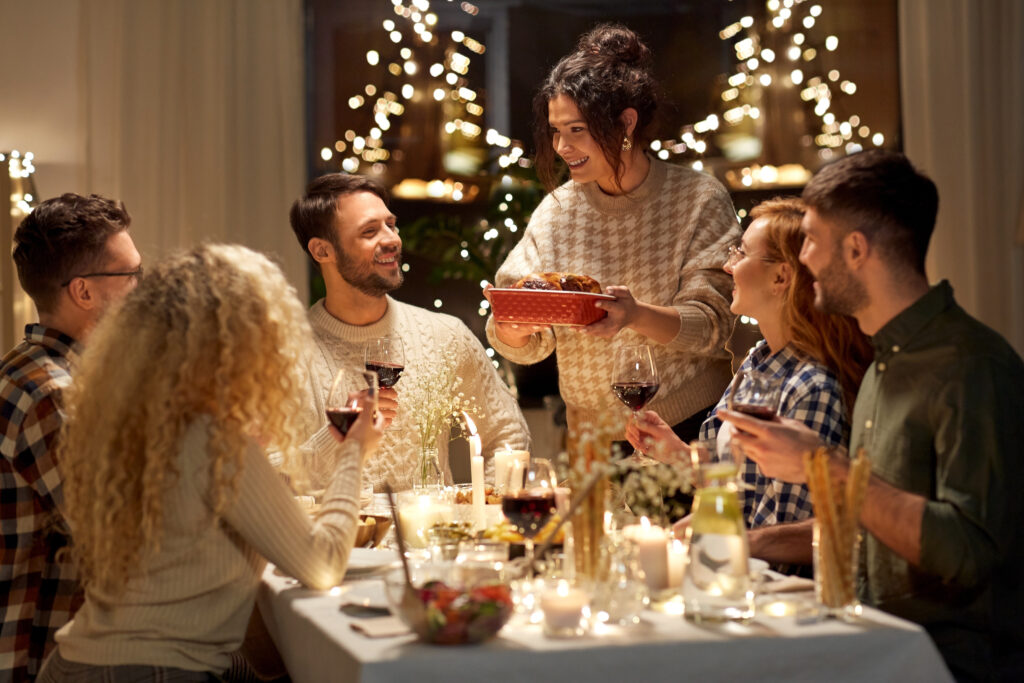Friends enjoying a festive dinner party in a Northamptonshire home with Chelton Brown's Christmas hosting tips.