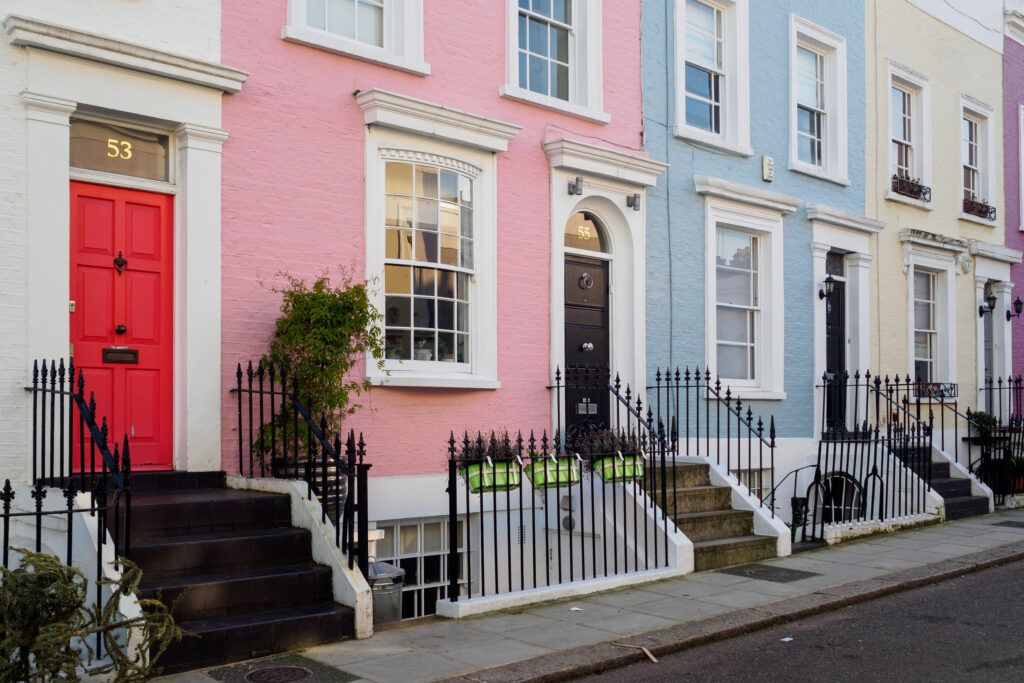 Row of colorful terraced townhouses in Northamptonshire, marketed by Chelton Brown estate and letting agents.